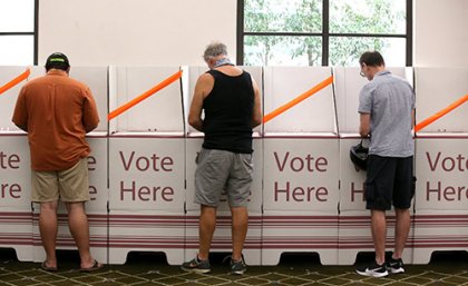 Men standing at Australian polling booths 